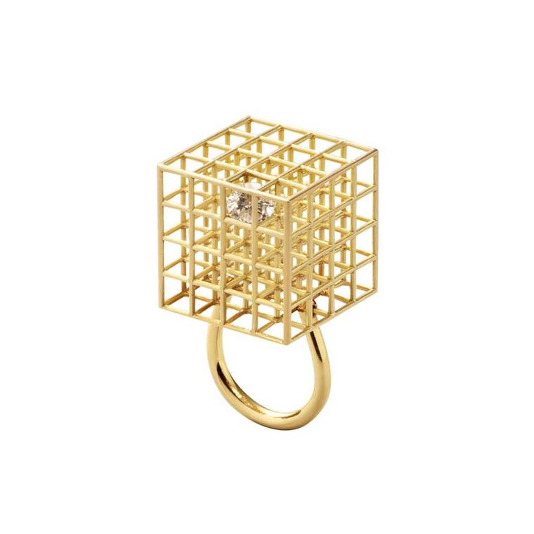 Jacqueline Rabun’s Grace ring, featuring a free moving solitaire diamond trapped within a golden cage, was inspired by the classic Rubik cube.