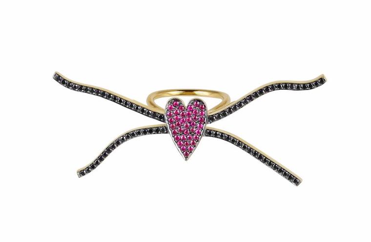Elena Votsi Eros across-the-finger ring in yellow gold with rubies and black diamonds.