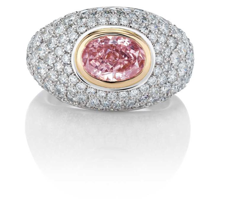 De Beers Aurora pink diamond ring, from the 1888 Master Diamonds and Creative Solitaires collection, set with an oval Fancy Intense pink diamond surrounded by pavé white diamonds.
