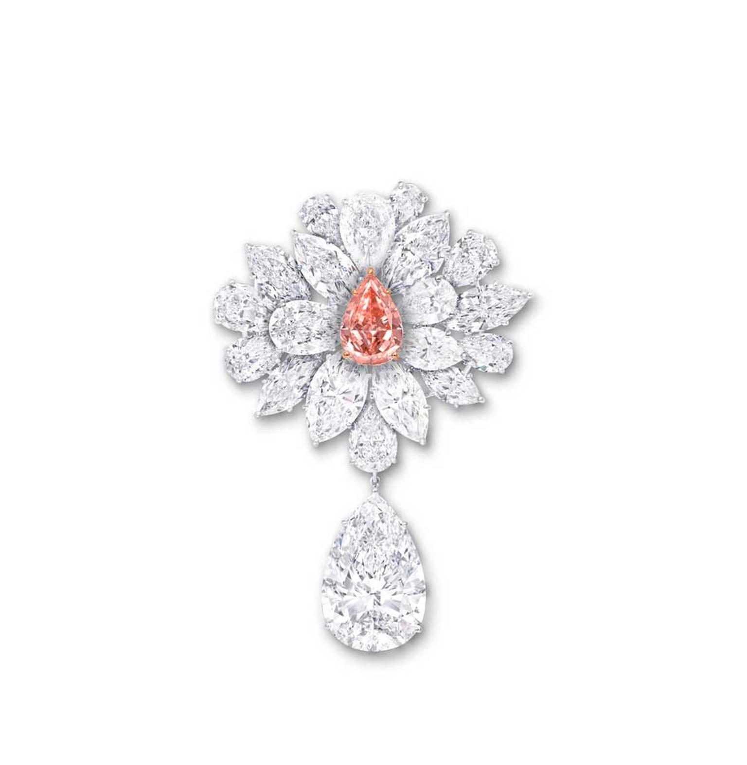 Graff's Diamond Flower Brooch, unveiled at the 2014 Biennale des Antiquaires in Paris, features an 8.97ct pear-shaped Fancy Vivid Pink Orange diamond, surrounded by a spray of white diamond petals and leaves.
