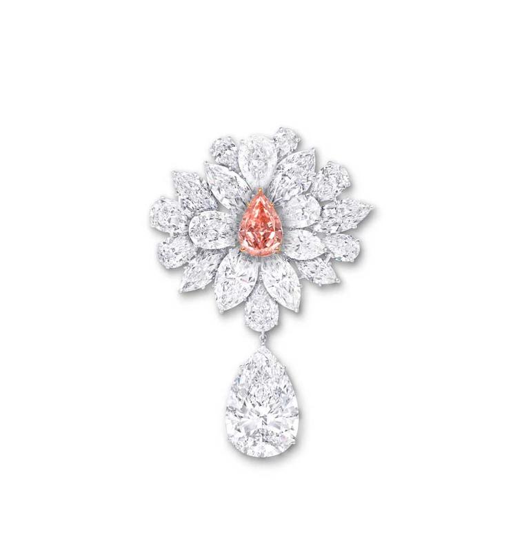 Graff's Diamond Flower Brooch, unveiled at the 2014 Biennale des Antiquaires in Paris, features an 8.97ct pear-shaped Fancy Vivid Pink Orange diamond, surrounded by a spray of white diamond petals and leaves.