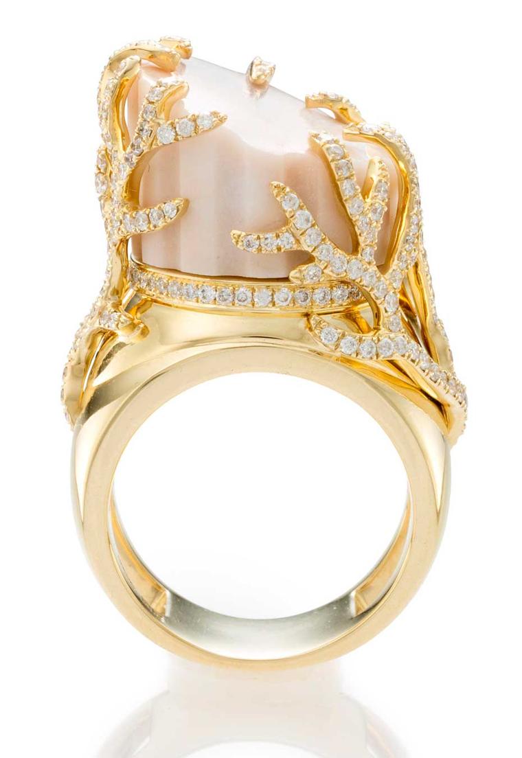 The marble in this CompletedWorks ring is surrounded by a circular-cut diamond and gold vine motif, with Great Britain assay marks.