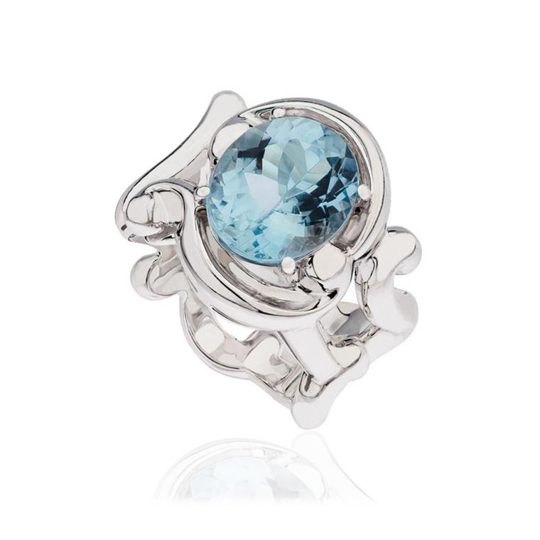 The lavish aquamarine and white gold cocktail ring from the Rococo collection by Fabergé features a sky blue, faceted, oval-cut aquamarine.