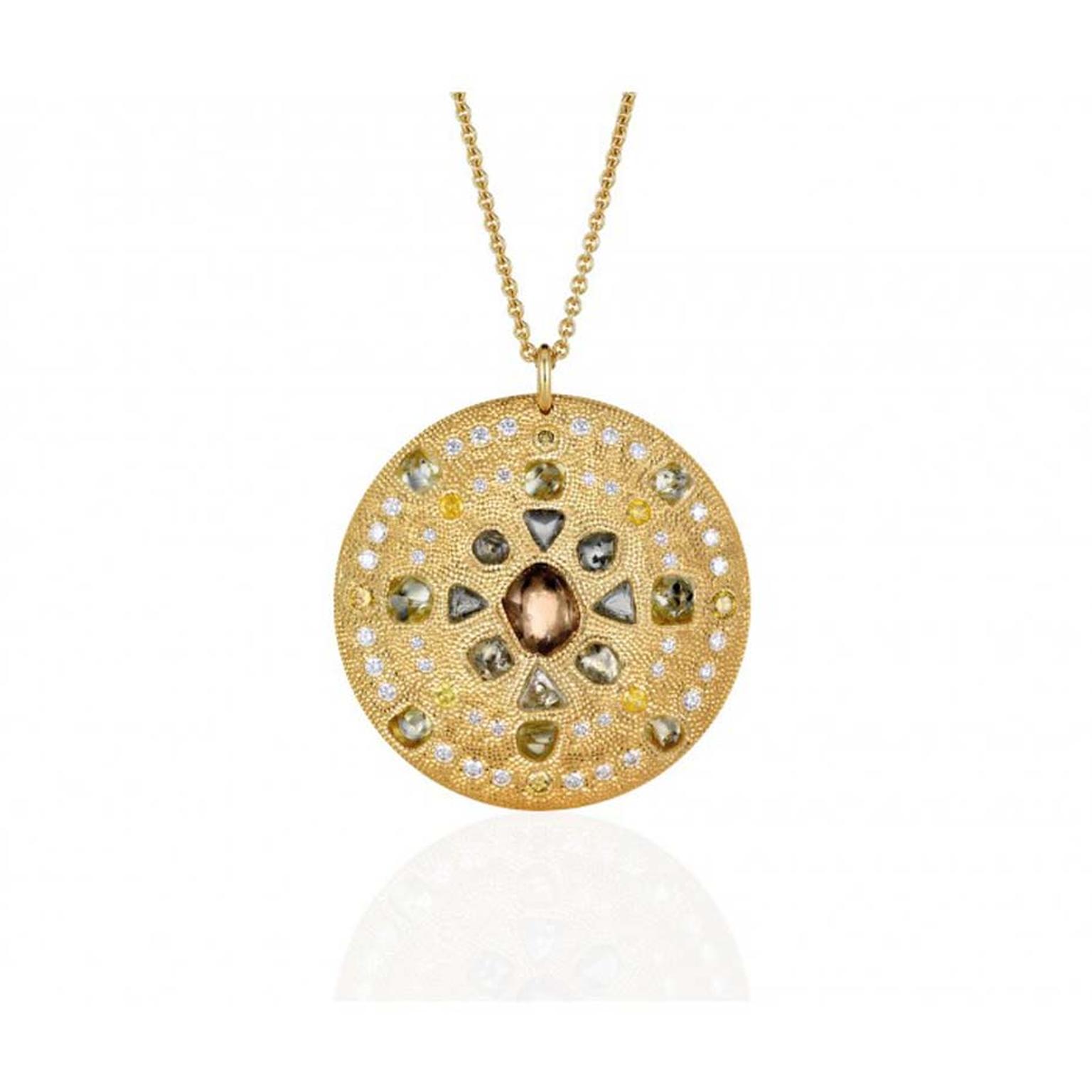 The De Beers Talisman Virtue Strength medallion necklace in yellow gold, set with rough green, brown and yellow diamonds, measures 44m across.