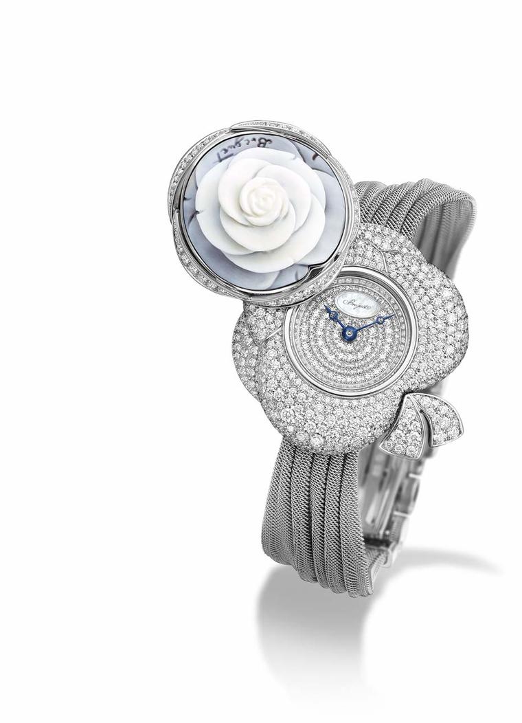 Breguet Rose de la Reine secret watch. By pressing on the dainty cameo rose, the cover pivots, revealing the scintillating dial of the watch, along with the spectacular diamond-set floral case and the ribbon that characterises the Rose de la Reine collect