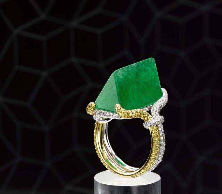 A polished rock of green jadeite, set in a yellow and white gold ring by Samuel Kung.