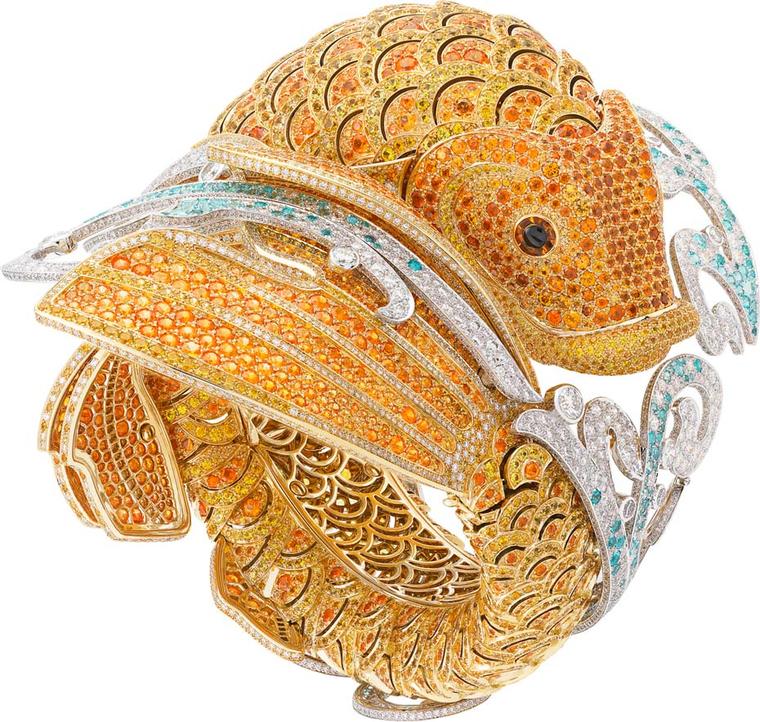 Van Cleef & Arpels Carpe Koï high jewellery watch features yellow sapphires and spessartite garnets set into the yellow gold scales. The lively spray of water is recreated with diamonds and Paraiba-like tourmalines.