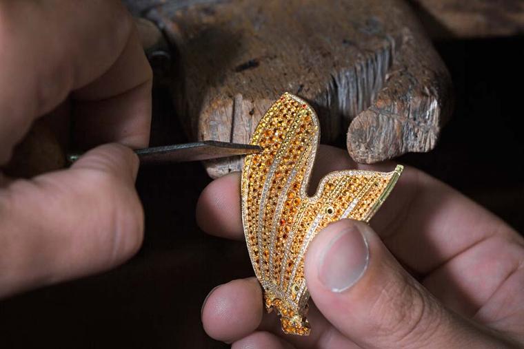 The 8,000 coloured stones used to make the Carpe Koï watch bracelet were selected by Van Cleef & Arpels to meet the highest standards of quality. In the photograph, the jeweller is setting gemstone beads into the tail.