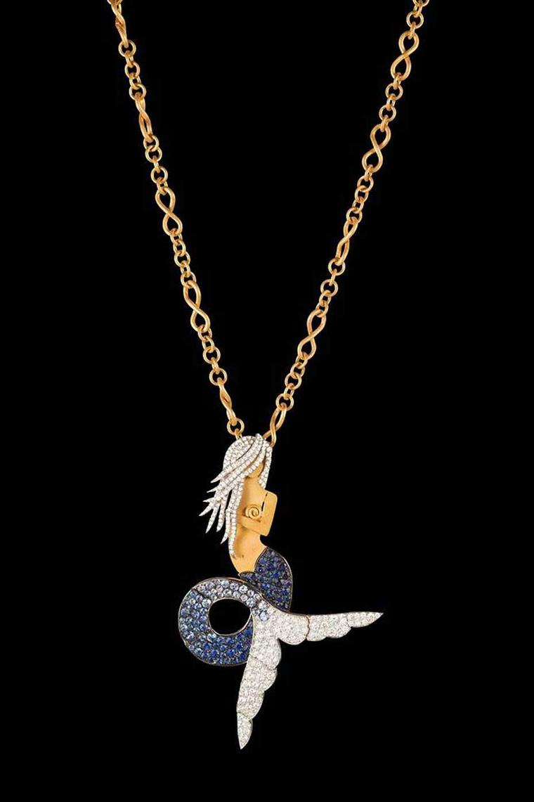 Liv Ballard's La Sirena "The Siren" necklace on a yellow and white gold chain, featuring a diamond and sapphire mermaid.