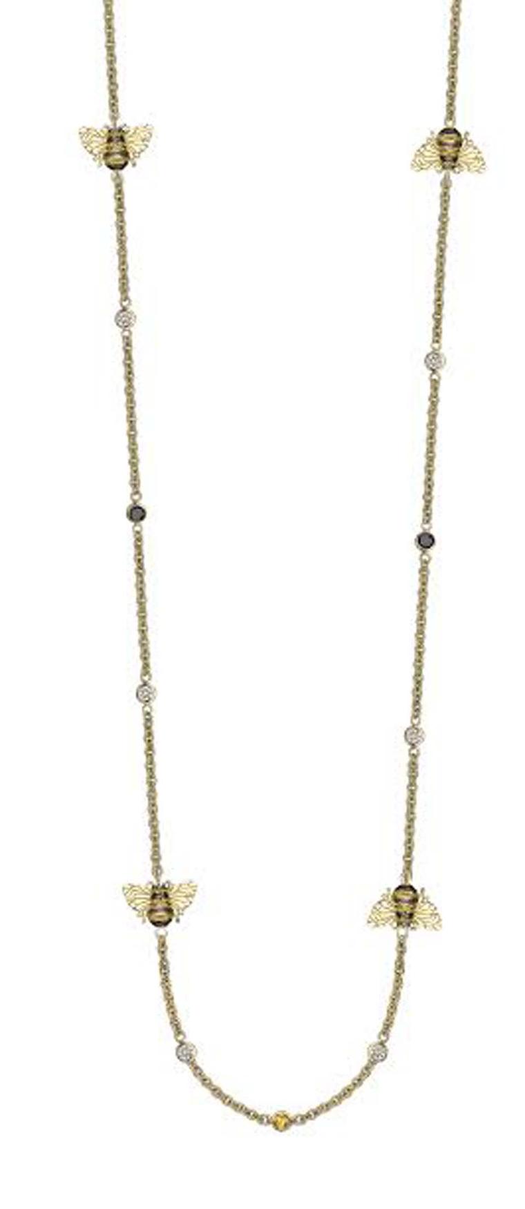 Theo Fennell bee necklace in yellow gold, with black and white diamonds and yellow sapphires.