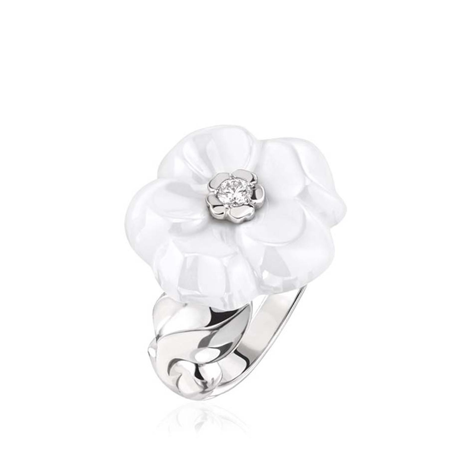 Chanel Camélia Galbé white ceramic ring, with a gleaming brilliant-cut diamond at its heart.
