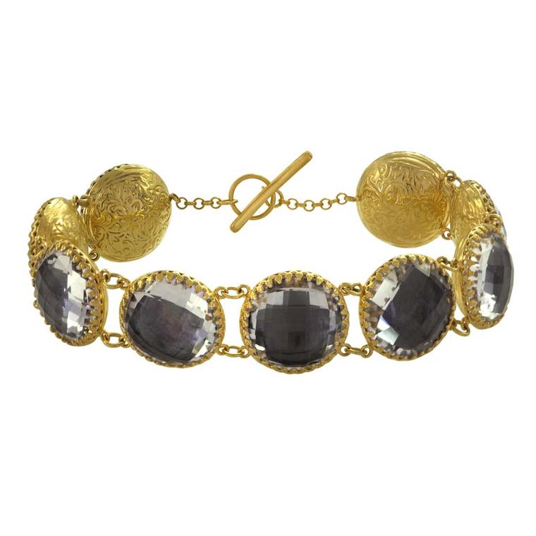 Larkspur & Hawk Olivia nine-stone button white topaz bracelet in yellow gold with grey foil ($2,250).