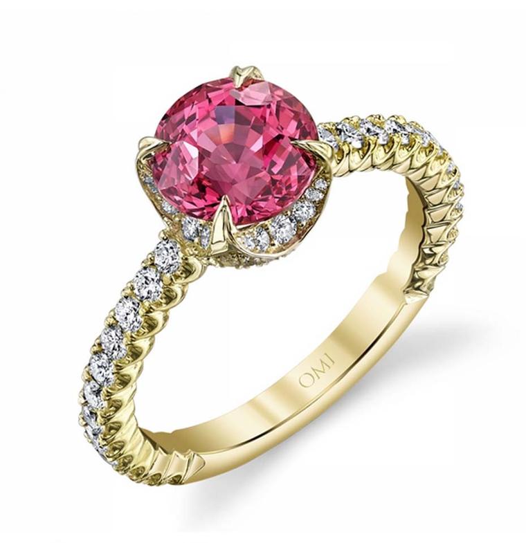 Omi Privé pink sapphire engagement ring featuring a round fancy-colour sapphire set in yellow gold with diamonds.