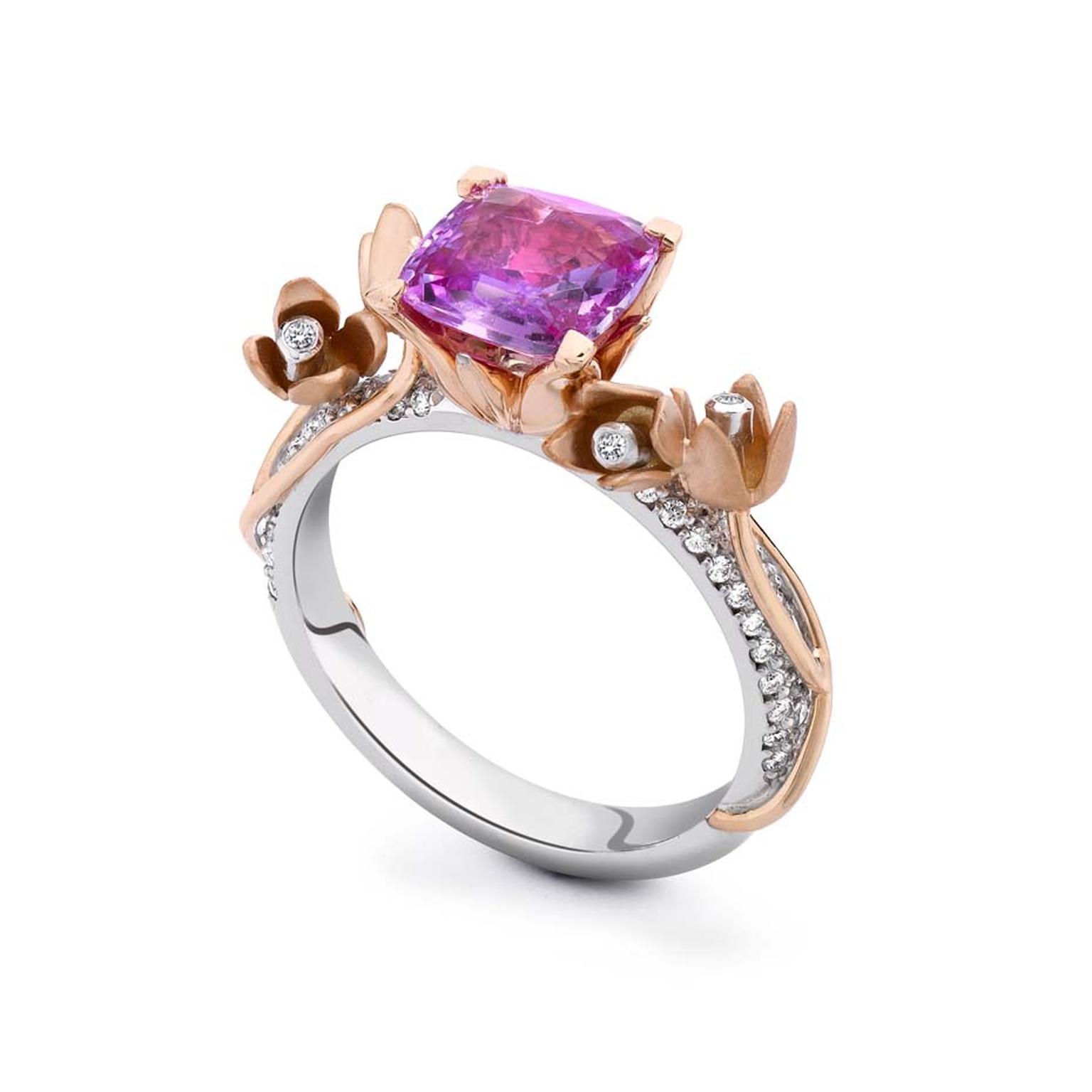 Theo Fennell engagement ring featuring a cushion-cut pink sapphire nestled in a rose gold floral setting on a white gold pavé band.