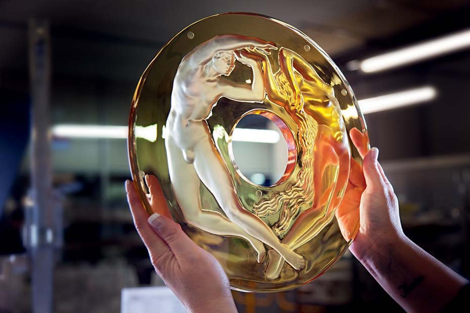 A glassmaker at Lalique inspects the crystal casing that will frame the Parmigiani clock.