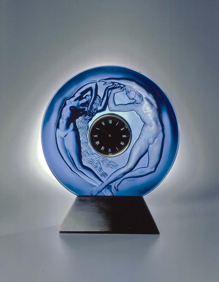 René Lalique's original Le Jour et la Nuit table clock of 1926 depicts a woman in relief on polished glass (night) and a man in counter-relief on satin-finished glass (day). The same mould has been used to create this new table clock, a collaboration betw