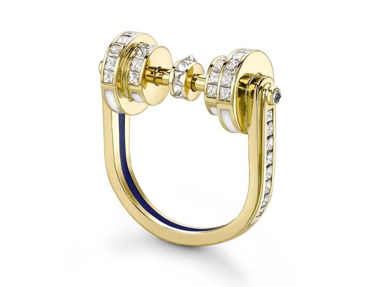 Emma Franklin diamond engagement ring in yellow gold with channel-set diamonds on all surfaces, blue sapphires, and enamel lines in blue and white.