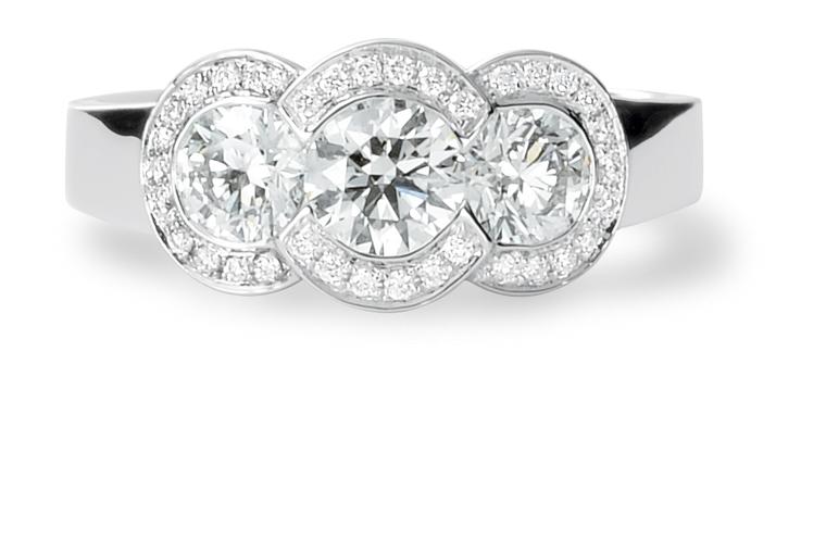 David M Robinson three stone engagement ring with diamond surround.