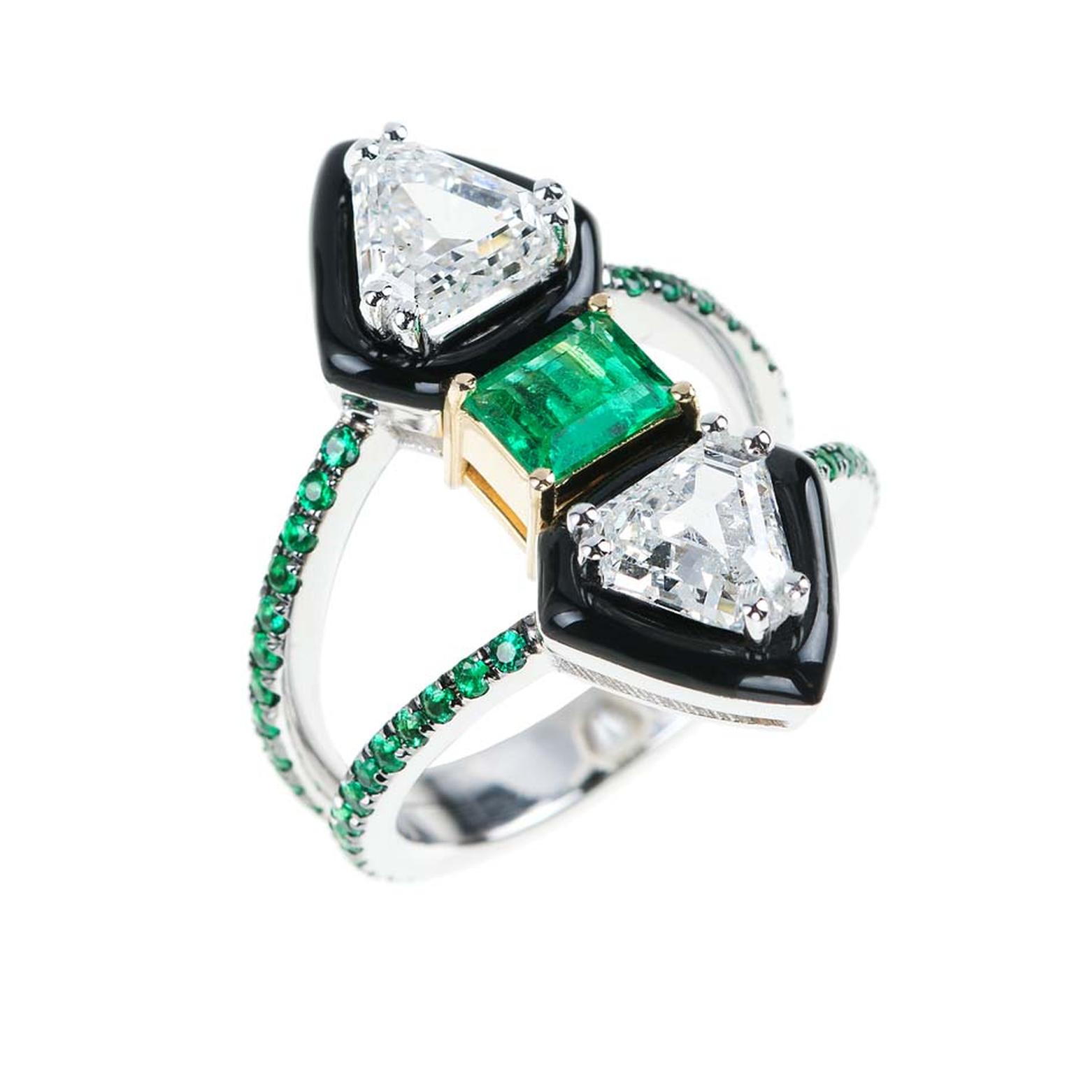 Nikos Koulis creates a powerful silhouette for his new "Oui" collection of unique engagement rings using black enamel. This diamond engagement ring is set with a central emerald and additional pavé emeralds around the double band.