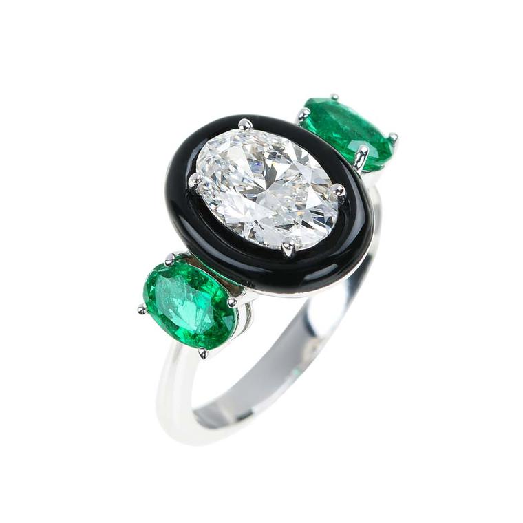 This unique engagement ring from the new "Oui" bridal collection from Nikos Koulis features an oval-cut diamond encased in black enamel with two emeralds either side.