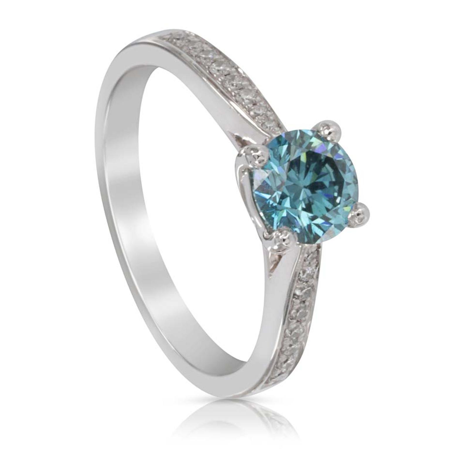 Blue and white diamond ring from Holts London featuring a round brilliant-cut treated blue diamond with diamond shoulders.