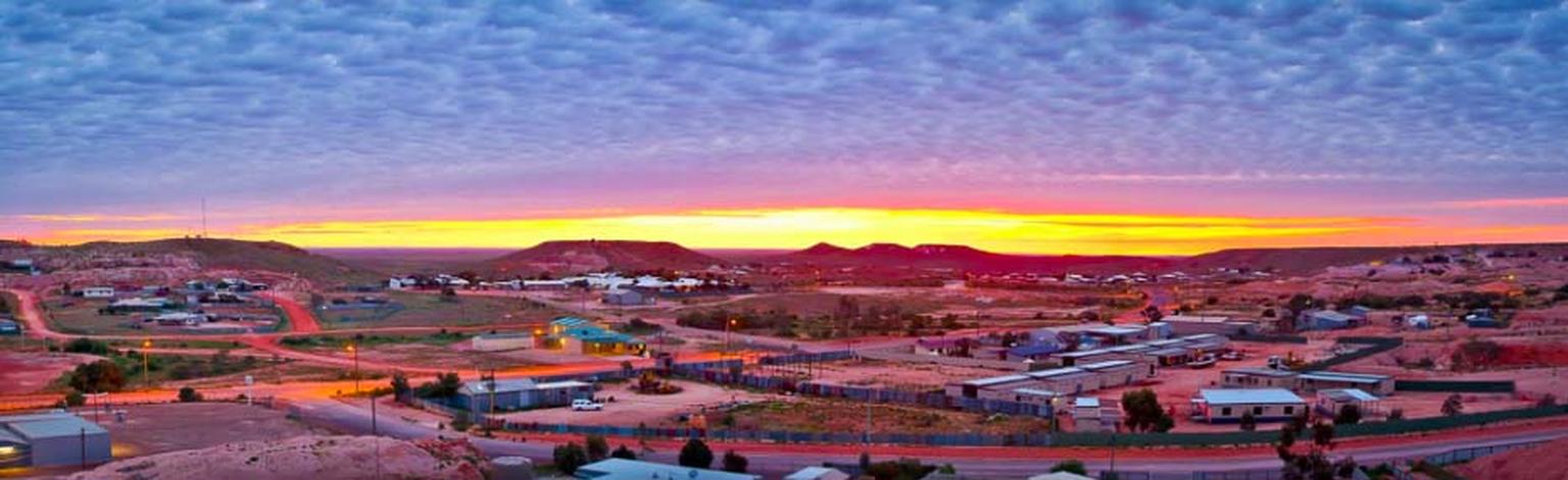 Sunrise over the town of Coober Pedy, known as the opal capital of the world, which provided the backdrop for the 1985 movie Mad Max: Beyond the Thunderdome. Photo: Courtesy of South Cape Photography / District Council of Coober Pedy.