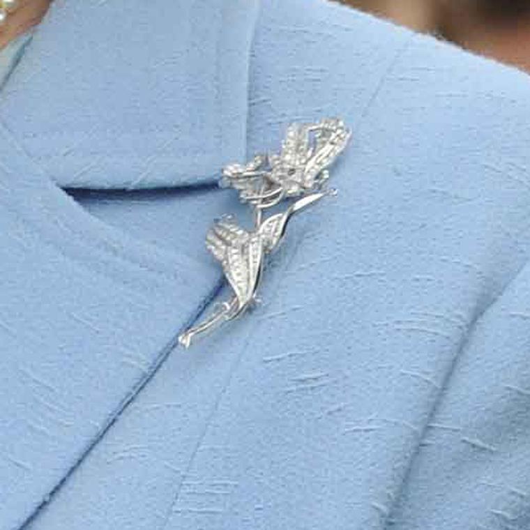 Close up the Queen's diamond flame lily brooch