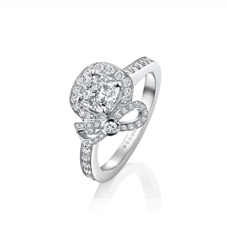 Boodles Vintage Rosette cushion-cut diamond engagement ring in platinum surrounded by melée diamonds and a pretty diamond bow.