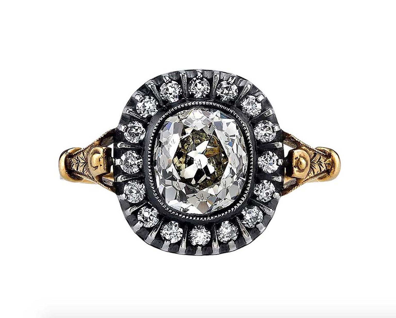 A classic Victorian design, this antique engagement ring features a cushion-cut diamond set in a handcrafted, oxidised, yellow gold and silver mounting, surrounded by a halo of diamonds. Available from 1stdibs.com.
