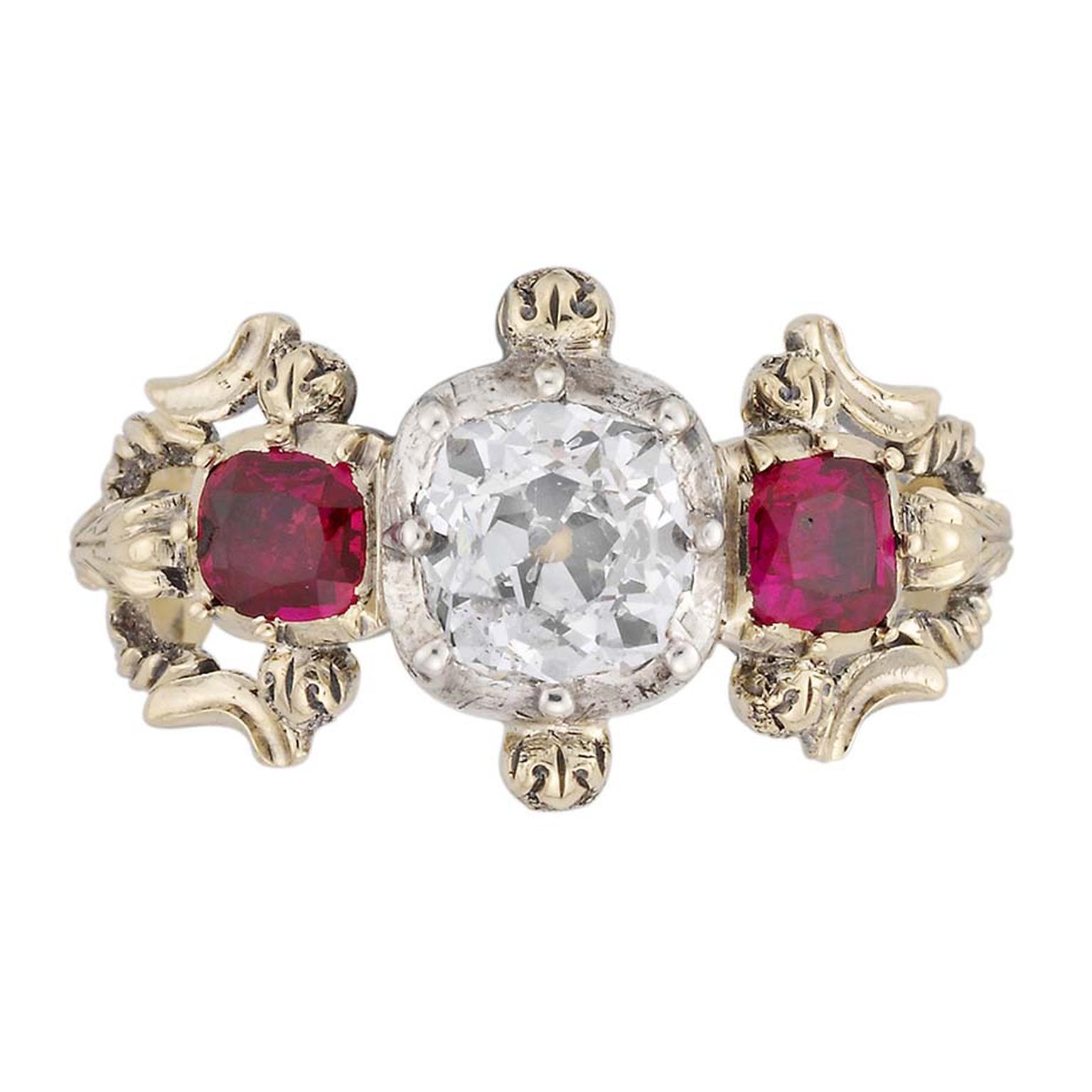 Bentley & Skinner three stone Victorian engagement ring with an old brilliant-cut diamond at its centre and two cushion-shaped rubies on either side. It dates from around 1850.