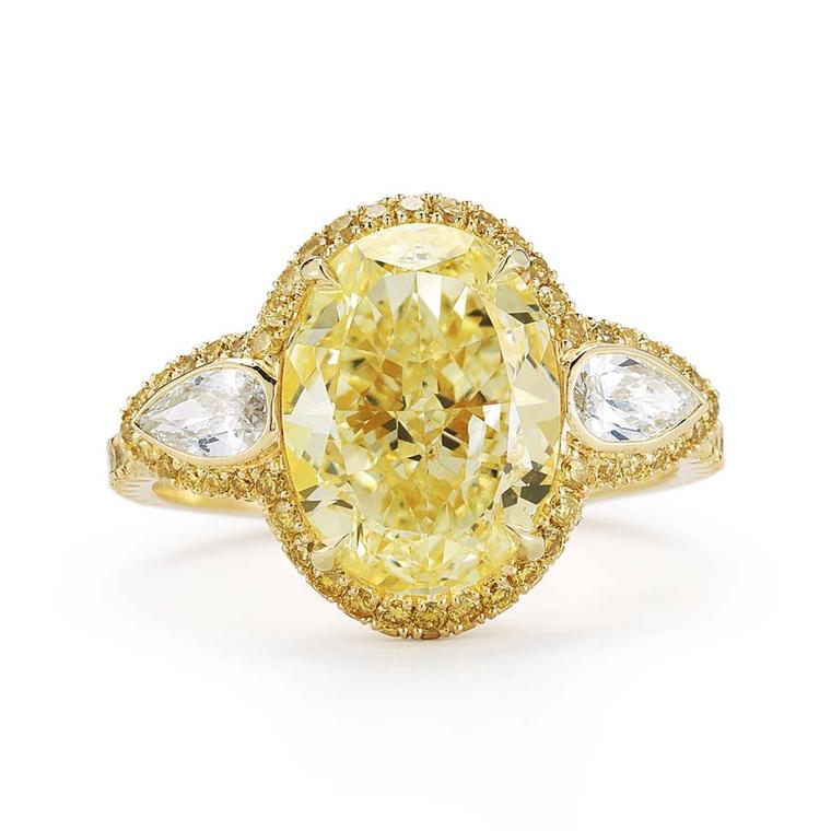 Kwiat oval-cut yellow diamond engagement ring in yellow gold, set with a 4.01ct Fancy light yellow diamond with bezel-set pear side stones and a yellow diamond pavé halo.