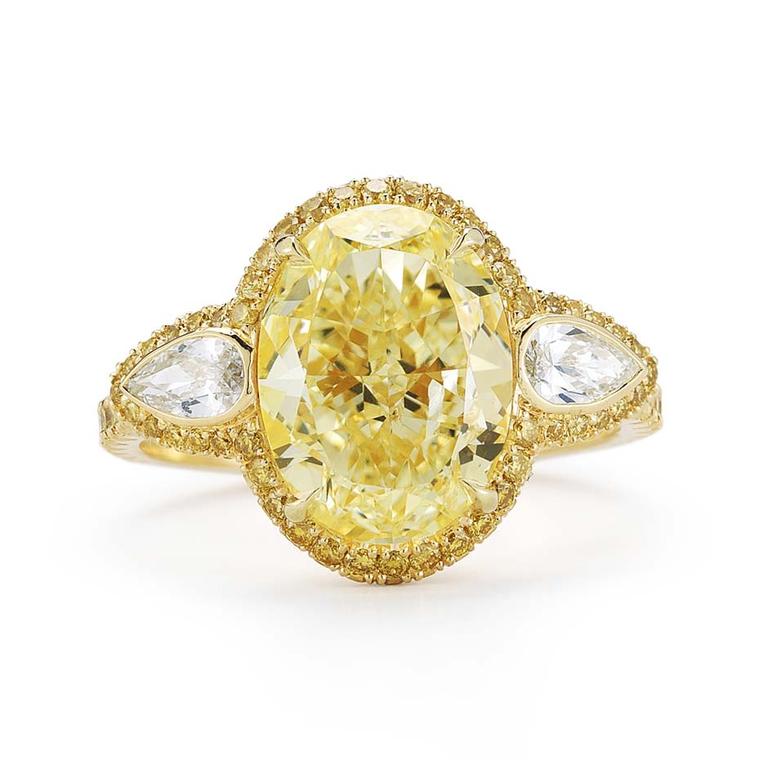 Kwiat oval-cut yellow diamond engagement ring in yellow gold, set with a 4.01ct Fancy light yellow diamond with bezel-set pear side stones and a yellow diamond pavé halo.