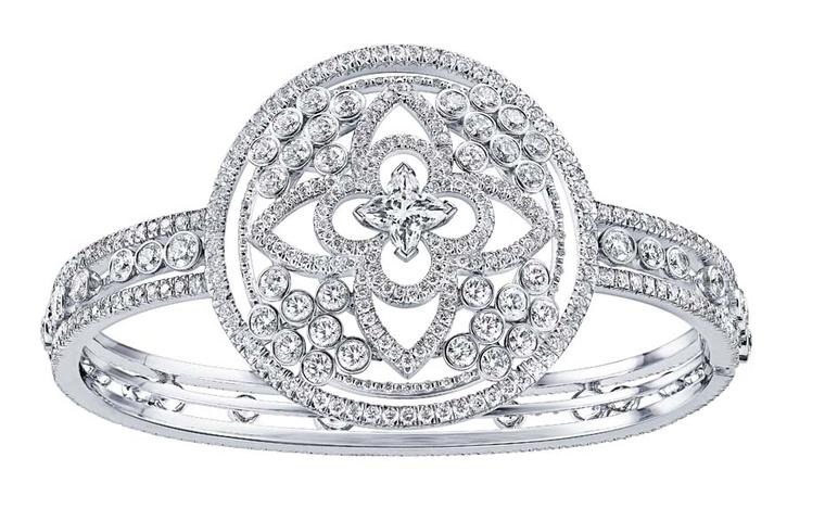 Diamonds fizz like bubbles around a star-cut diamond at the heart of this Louis Vuitton Monogram Fusion cuff bracelet.