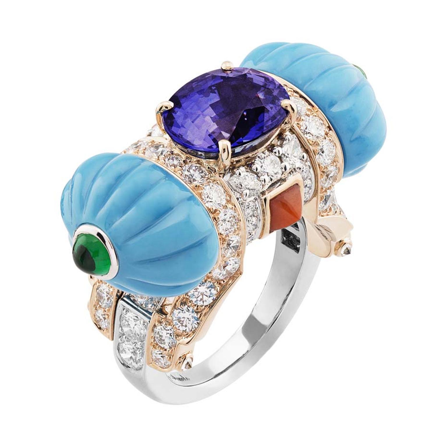 The Cadeau d'Orient white and pink gold ring with turquoise, coral, emeralds, diamonds and a centrally set oval cut purple sapphire.