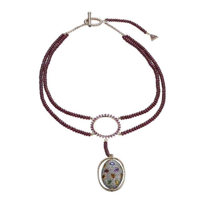 Misahara limited-edition Sahara necklace in gold with two strands of ruby beads and a multicolored gemstone pod that turns freely.