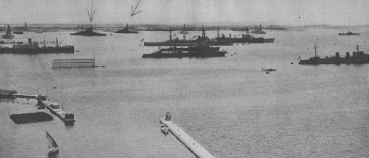 A photograph of the port of Alexandria, Egypt with two battleships targeted by the Italian Navy.