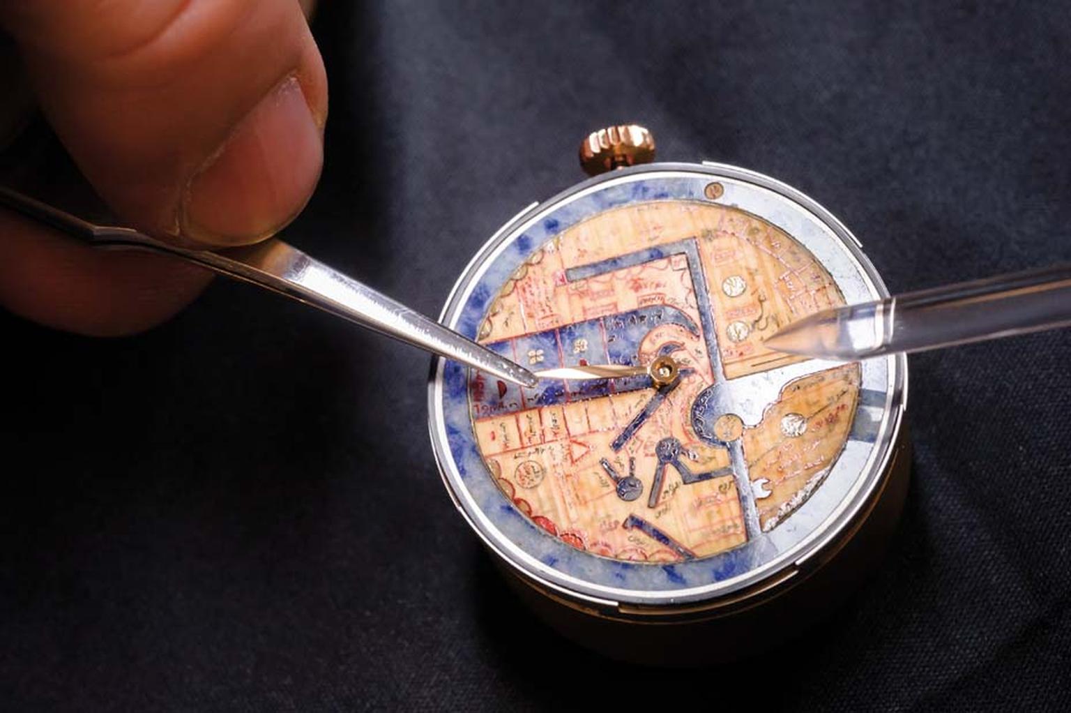 The blue sodalite stone on the dial of the Pearl of Wonders watch has been decorated with miniature inlaid pieces of papyrus to recreate the texture and colour of the original parchment.
