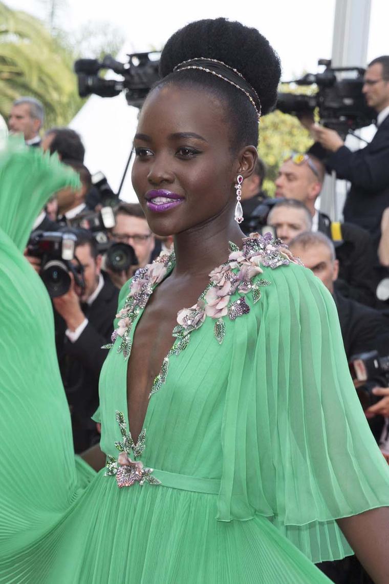 Oscar-winning actress Lupita Nyong'o stepped onto the red carpet of the 68th annual Cannes Film Festival wearing a swirling mint green Gucci gown, accessorised with a pair of Chopard Red Carpet collection diamond drop earrings.