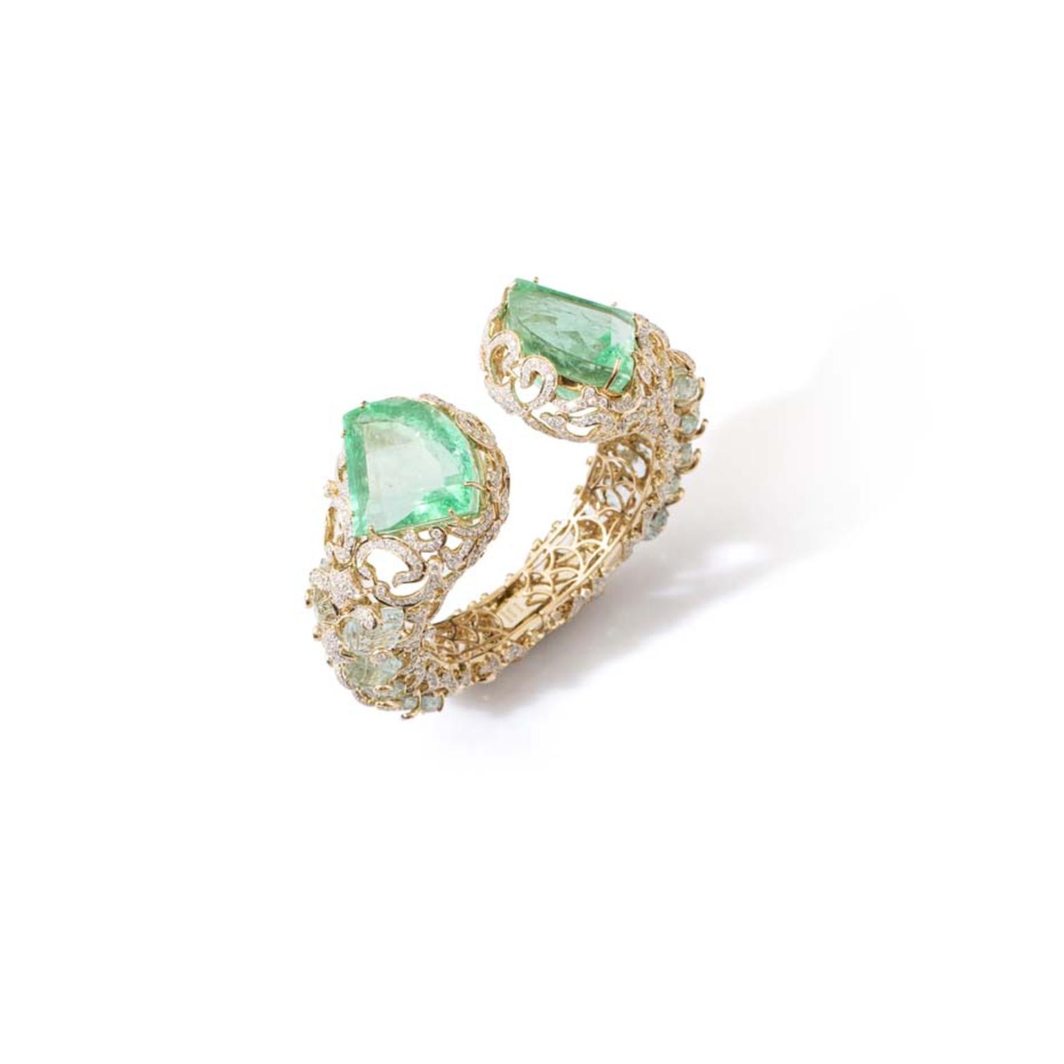 Le Jardin Exotique Colombian emerald cuff set with two kite-shaped emeralds weighing 151.24ct, carved aquamarine leaves and diamonds in yellow gold.