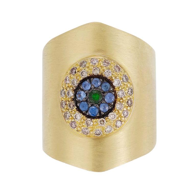 Ileana Makri Round Eye Shield ring in yellow gold with champagne diamonds, blue sapphires and a tsavorite center ($4,660).