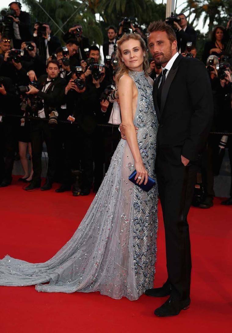 Actress Diane Kruger walked the red carpet in Cannes wearing a pale blue backless Prada dress accessorised with classic white diamond Harry Winston jewellery.