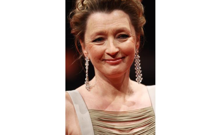 Close-up of Lesley Manville at 2011 BAFTAS wearing Chopard diamond earrings and watch