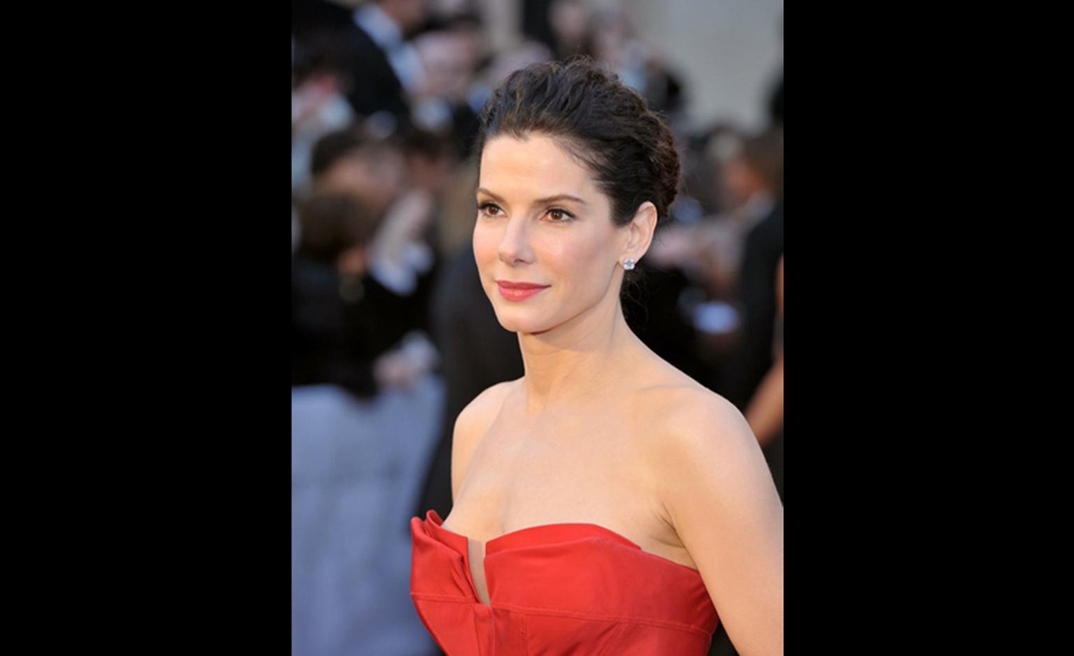 Sandra Bullock wearing Harry Winston emerald-cut diamond earstuds, 5.5 carats each