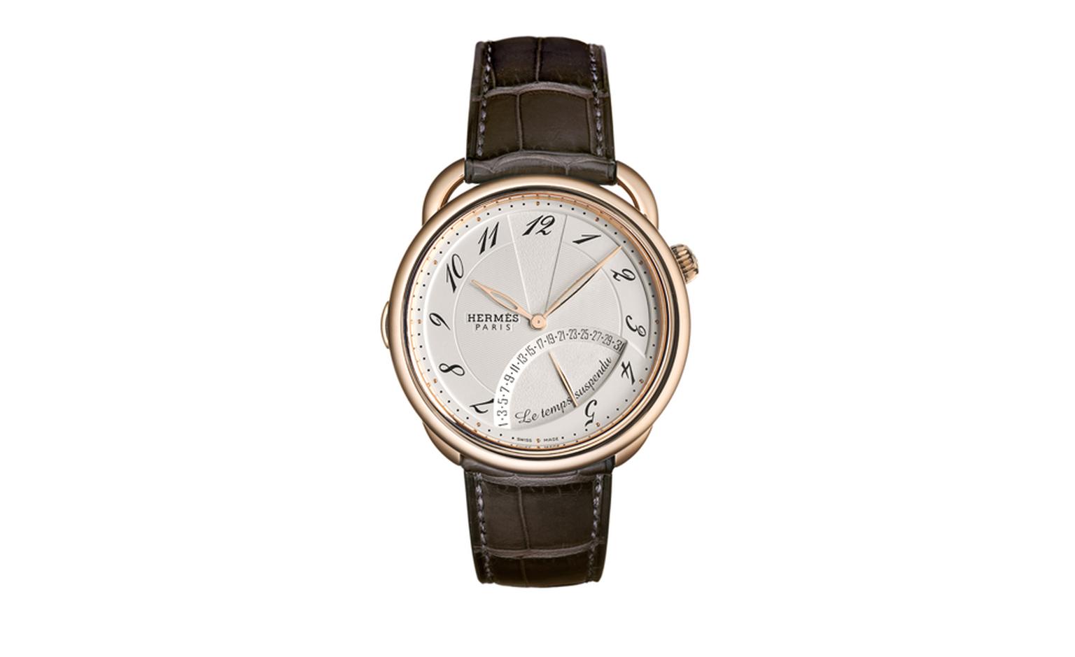 HERMES, Temps Suspendu is mechanical watch in rose gold with a brand new complication. Push the crown to suspend time at which point the two hands will sit at 12  o'clock until the crown is pushed again to resume timekeeping function.