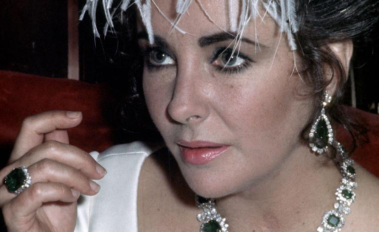 Elizabeth Taylor wearing Bulgari jewels. En tremblant brooch with diamonds and emeralds, an emeralds parure (gift of Richard Burton). Image courtesy of Bulgari. Credit, Getty Images.