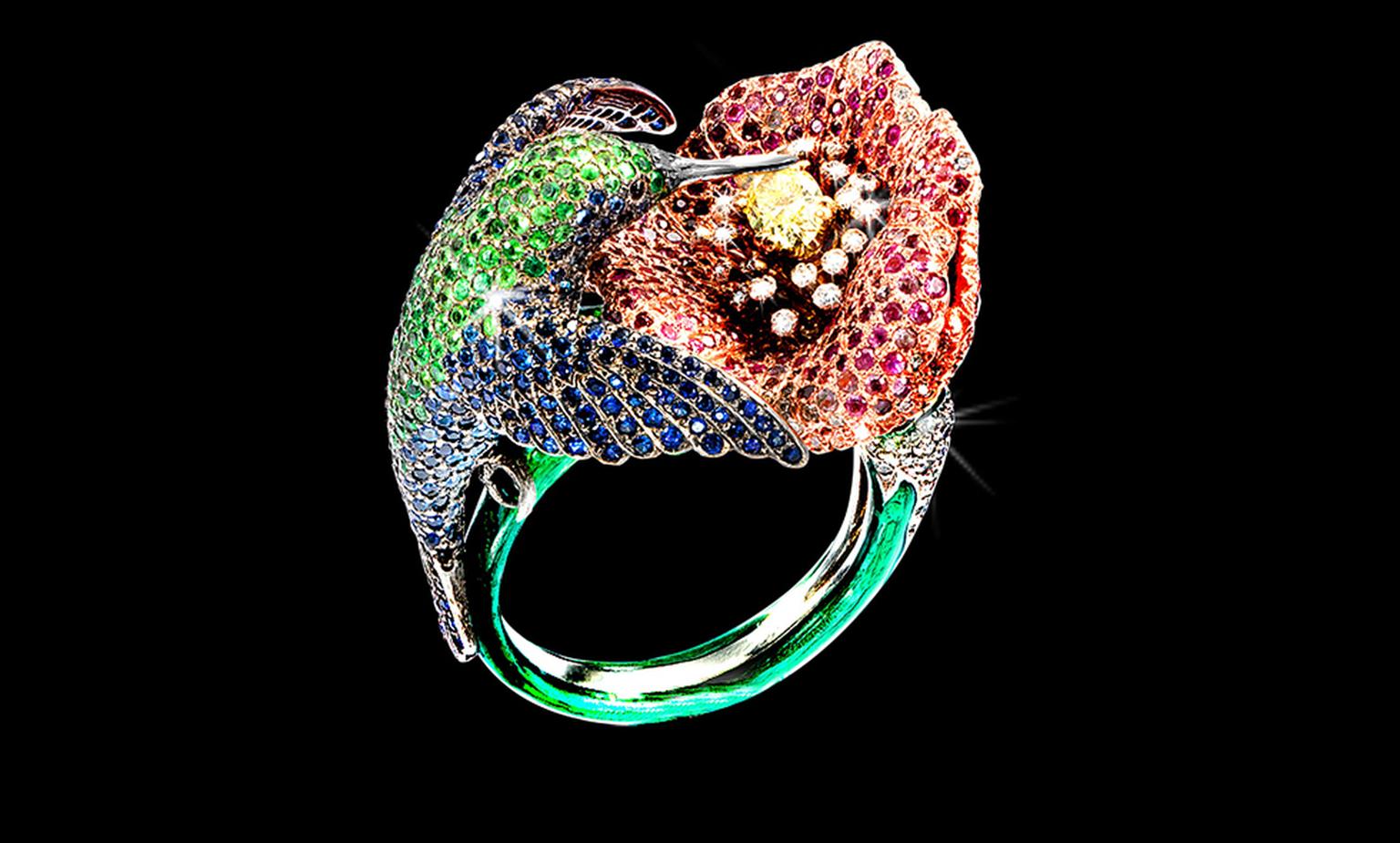 George Pragnell hummingbird ring is adorned with sapphires, green tsavorites and aquamarines and the flower is made up of rubies, pink sapphires and diamonds and at the centre is a fancy intense yellow diamond. Not for sale