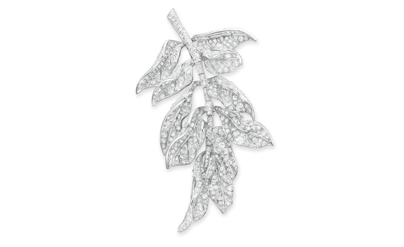 LOT 53 A DIAMOND AND PLATINUM BROOCH  Designed as an articulated cluster of old mine, old European and single-cut diamond scrolling leaves, to the single-cut diamond stem, mounted in platinum, circa 1940 Likely by Paul Flato Estimate $12,000-$18...