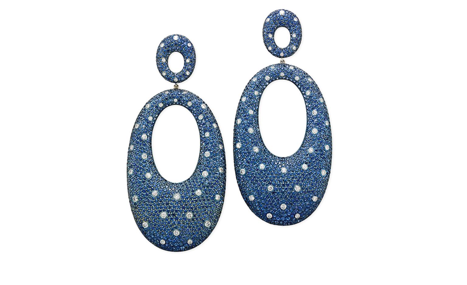 Lot 28. A pair of sapphire, diamond and titanium ear pendants. Each ear pendant designed as an oval titanium hoop mounted with pavé-set circular-shaped sapphires interspersed with brilliant-cut diamond collets of 'polka dot' motif suspended from...