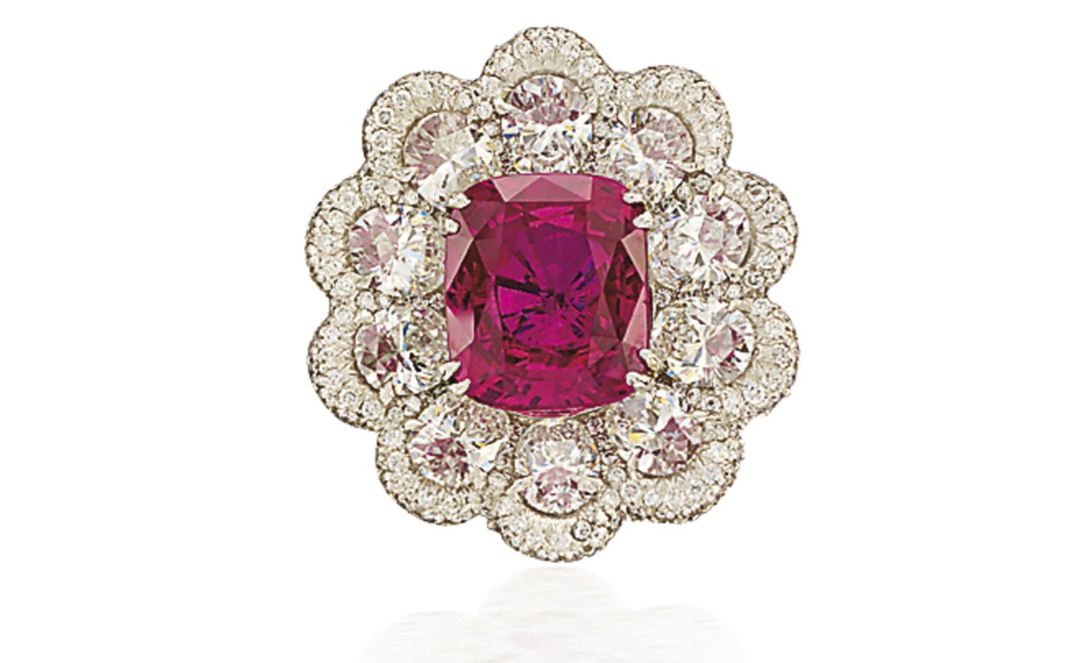 Lot 72. A fine ruby and diamond ring. Designed as a cluster centring upon a cushion-shaped ruby weighing 7.01 carats surrounded by oval-shaped diamonds weighing a total of 4.18 carats to the pavé-set diamond scalloped border and similarly-set di...