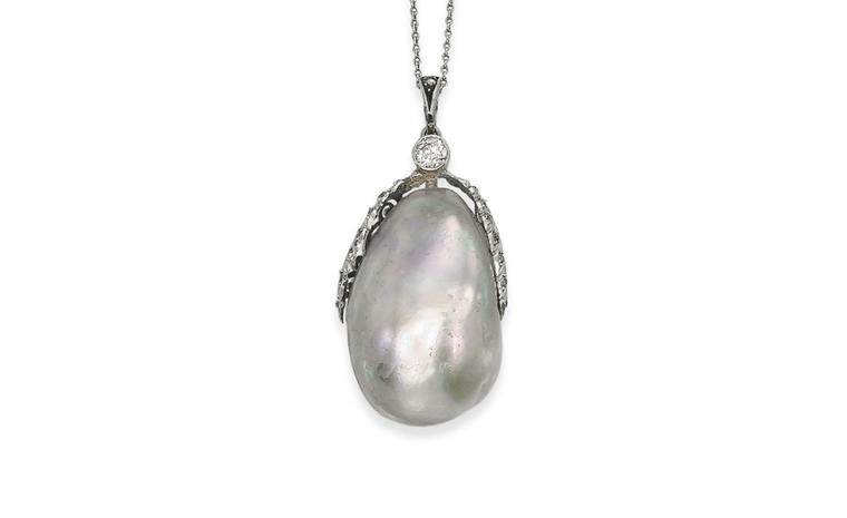 Lot 79. An important natural pearl. The baroque drop-shaped natural pearl weighing 239.7 grains (59.92 carats) to the circular-cut diamond foliate surmount and spectacle-set diamond chain, 42.0 cm long, with fitted case and book 'H. Bari and D.L...